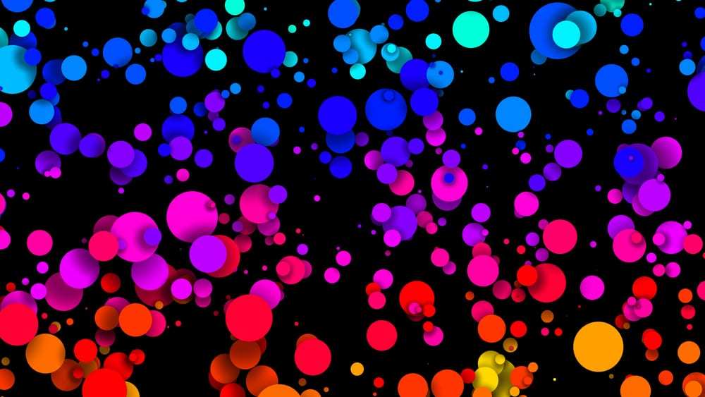 Graphic depicting multi-colored circles of various sizes on black background