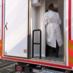 Medical professional standing inside emergency mobile medical vehicle