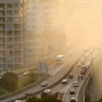 Air pollution in busy city, near highway and apartment buildings