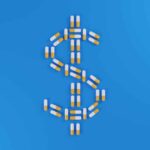 Yellow and white pills forming a dollar sign on a blue background